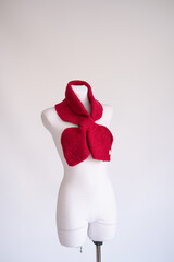 Bold Red Knitted Scarf with unbranded text Handmade on the tag on Mannequin for Sustainable Fashion