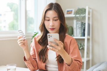 Health care asian young woman using smart mobile for reading, searching prescription medicine,...