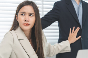 Unhappy, disgusted asian young employee, business woman defending hand of colleague, push out protect when boss touching her body, embrace shoulder. Sexual harassment inappropriate at office,workplace