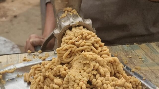 A man is making chicken mince with a machine. Grinding of meat with a manual meat grinder. Man making minced chicken using an manual meat grinder. 4K Footage