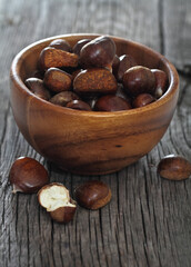 Roasted chestnuts on wooden background