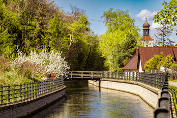 Beautiful spring countryside in Europe. Ancient church on the canal