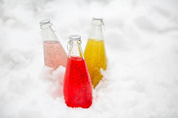 Three healthy drinks with chia seeds (lat. Salvia hispanica) ion the snow. Health and diet concept