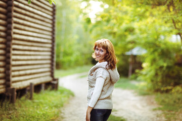 Portrait of a smiling red haired woman in autumn day