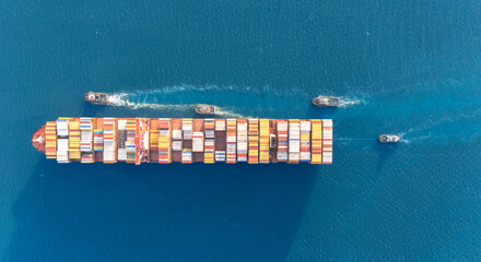 Top view Container ship full capacity approaching the port by a tugboat occupying the port International Container ship loading, unloading at sea port, Freight Transportation, Shipping,   Logistics,