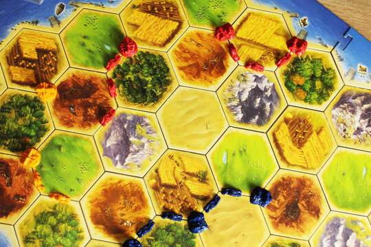 Mozyr, Belarus, April 01 2024: board game catan colonizers. A tiger field with players' chips, top view. Family Fun