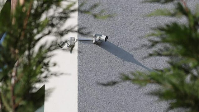 CCTV surveillance video. 4K video with two surveillance cameras placed on the exterior wall of the house to protect from robbery. Home security.