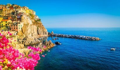 Manarola picturesque town and sea of Cinque Terre at summer with blooming flowers, Italy