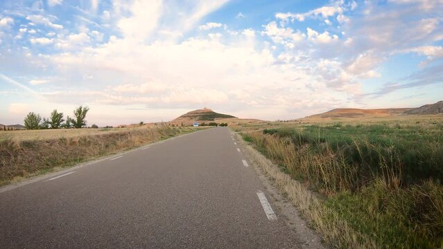 French Way of Saint James - a paved road approaching Castrojeriz in summer, province of Burgos, Castile and Leon, Spain
