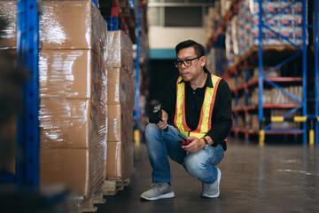 Warehouse worker working and checking the stock in the warehouse. .Factory manager using digital...