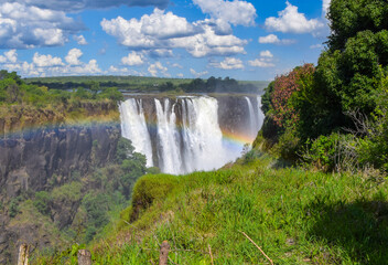 Victoria Falls, aka Mosi-Oa-Tunya waterfall, view from the Zimbabwe side at low water levels, with a rainbow