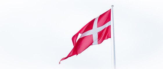 Flag of Denmark on white cloudy sky background. Danish flag waving in wind. 