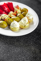 antipasti mix olives, mozzarella, stuffed peppers, mushrooms antipasto fresh food tasty eating appetizer meal food snack on the table copy space food background