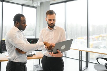 Two diverse crypto traders brokers stock exchange market investors discussing trading charts research reports growth using pc computer looking at screen analyzing invest strategy, financial risks