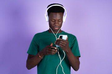 Man Wearing Headphones Looking at Cell Phone