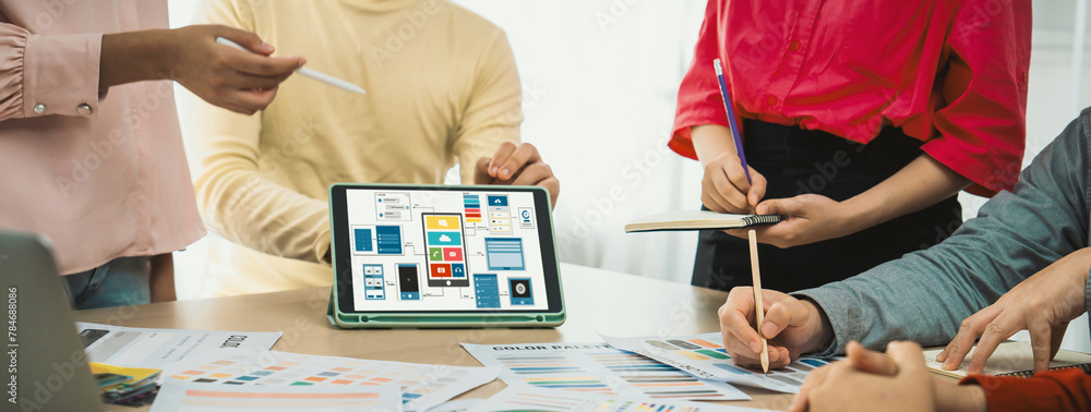 Poster cropped image of interior designer team chooses color from color swatches while tablet displayed ui 