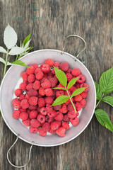 Ripe raspberries in a vintage sieve