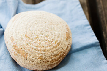 Fototapeta na wymiar A round loaf of bread on a napkin