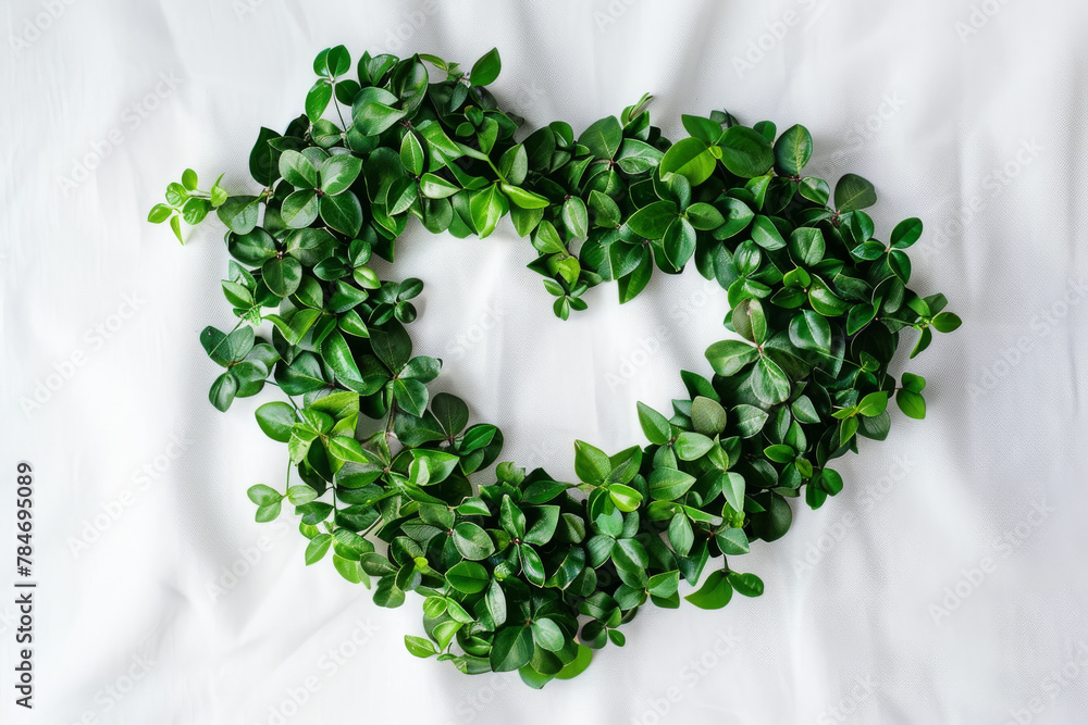 Poster Fresh Green Leaves Shaped into a Heart on White Linen Background