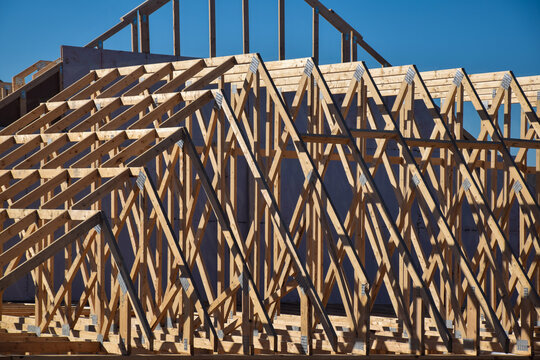 Closeup rafters and trusses roof framing on a new residential home construction