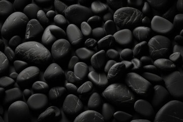 Fototapeta premium Smooth black pebbles with subtle highlights, ideal for zen-inspired themes and minimalist designs