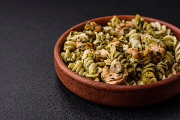 Delicious pasta with spinach, salmon, salt and spices