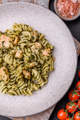 Delicious pasta with spinach, salmon, salt and spices