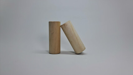 two wooden sticks on a white surface