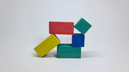 stack of colorful puzzle blocks on white surface