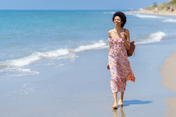 Happy ethnic woman on sandy seashore - 784714835