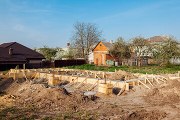 Building house. Concrete foundation surrounded with wooden decking is done for new future home. Constructing base