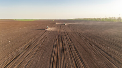 Tractors sowing the crop, using GPS antennas for straight parallel lines