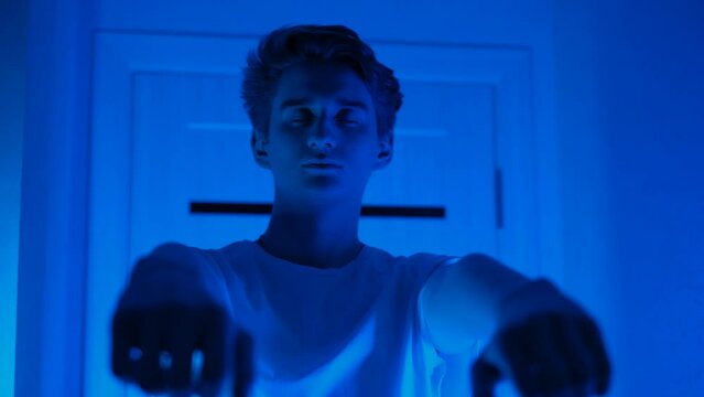 Sleeping young man walking around the room at night. Sleepwalking and sleep disorder concept