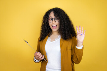 African american business woman with paperwork in hands over yellow background showing and pointing up with fingers number four while smiling confident and happy