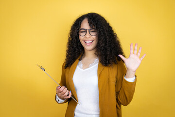 African american business woman with paperwork in hands over yellow background showing and pointing...