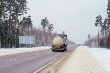 A tank truck transports a product along a highway