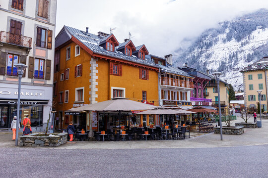 Chamonix-Mont-Blanc, France - April 1, 2018 : A few cafes along the central square in Chamonix with resting tourists. Chamonix is one of the oldest ski resorts in France.