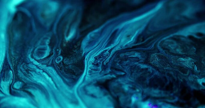 Acrylic paint blend. Glitter ink. Defocused blue black color shiny dust sequin particles texture pigment water emulsion fluid flow motion abstract art background.