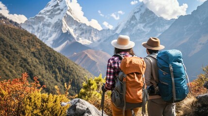 A couple of people with backpacks admiring a mountain view - obrazy, fototapety, plakaty