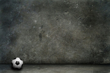 soccer ball in an empty room with concrete wall and floor