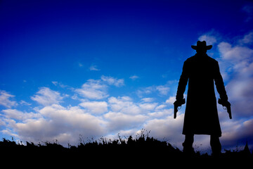 silhouette of a gunman with guns in the hands