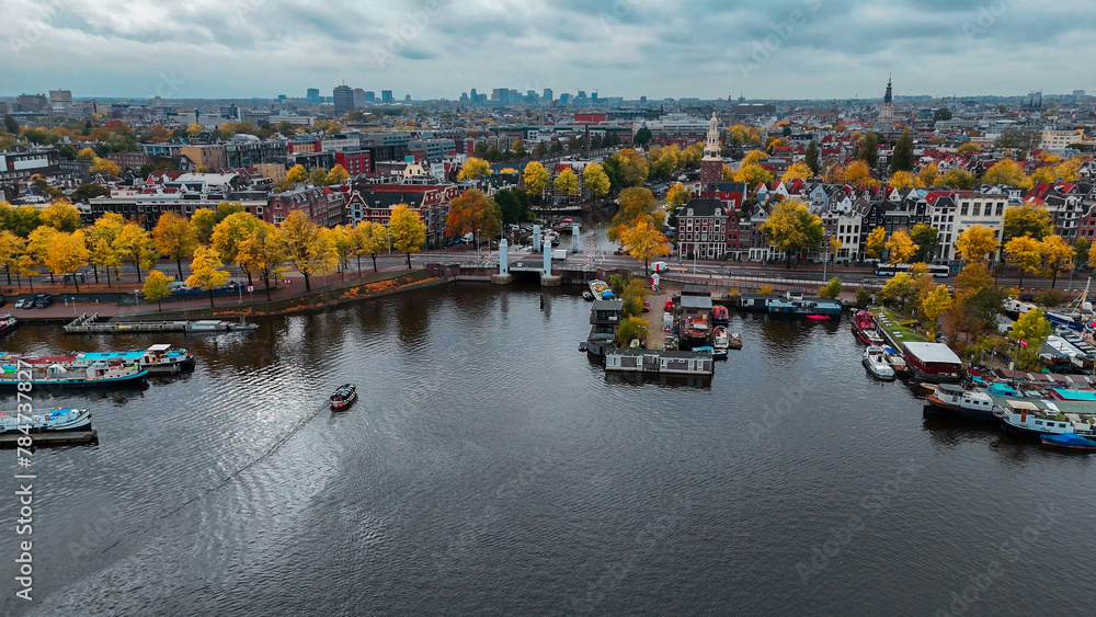 Wall mural Aerial drone view Amsterdam autumn cityscape narrow old houses, canals, boats bird's eye view