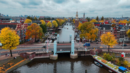 Fototapeta na wymiar Aerial drone view Amsterdam autumn cityscape narrow old houses, canals, boats bird's eye view