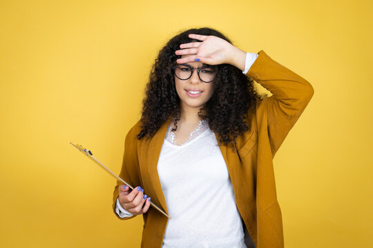 African american business woman with paperwork in hands over yellow background Touching forehead for illness and fever, flu and cold, virus sick
