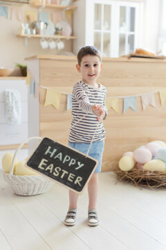 Child holds chalkboard with Easter sign