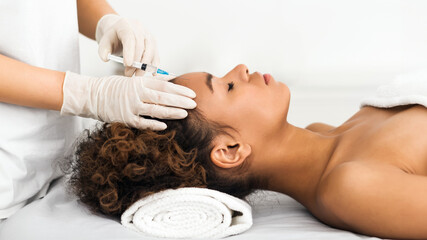 Obraz na płótnie Canvas Aesthetic surgery. Woman having injection on forehead