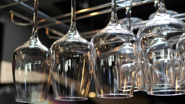 Clean glasses hang upside down over the bar counter