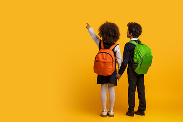 Fototapeta na wymiar Two kids holding hands ready for school