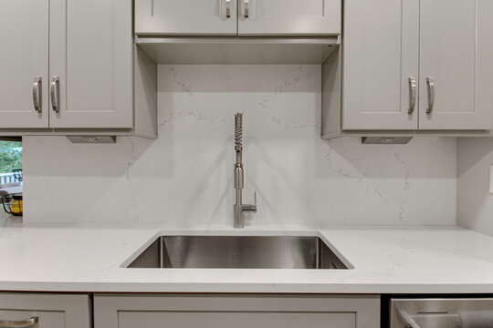 Modern Kitchen Sink with High Quality Pull Down Faucet Design, Neutral Cabinets and Marble Stone Backsplash