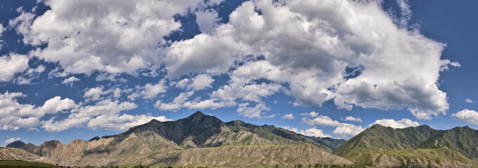 Altai mountains under blue sky and clouds panorama
